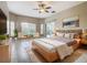 Relaxing main bedroom with wood bed frame and sitting area at 900 Shorehaven Drive, Poinciana, FL 34759
