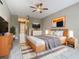 Main bedroom with wood bed frame and view of bathroom at 900 Shorehaven Drive, Poinciana, FL 34759