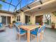 Outdoor patio with dining table, cozy furniture, and a view to the interior at 900 Shorehaven Drive, Poinciana, FL 34759