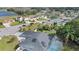 Aerial view of a home with solar panels, a screened-in pool, and a large body of water at 918 San Paulo Way, Kissimmee, FL 34758