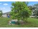 Picturesque backyard featuring lush lawn and mature trees, offering privacy and shade at 918 San Paulo Way, Kissimmee, FL 34758
