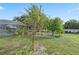 Expansive backyard featuring tropical landscaping, lush lawn and covered lanai area at 918 San Paulo Way, Kissimmee, FL 34758