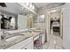 Bathroom with double sinks, granite counters, and a doorway leading to a sunroom at 918 San Paulo Way, Kissimmee, FL 34758