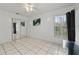 Bright bedroom with tile flooring, neutral walls, and a corner window at 918 San Paulo Way, Kissimmee, FL 34758