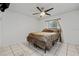 Bedroom with a ceiling fan, white walls, tile flooring, and a comfortable bed at 918 San Paulo Way, Kissimmee, FL 34758