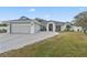 Charming home with a gray garage door, fountain, and a well manicured lawn at 918 San Paulo Way, Kissimmee, FL 34758