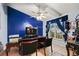 Home office with a decorative blue accent wall, built-in shelving, and natural light at 918 San Paulo Way, Kissimmee, FL 34758
