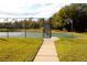 Basketball court with chain link fence and paved walkway at 1068 Lake Berkley Dr, Kissimmee, FL 34746