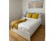 Bedroom with white platform bed and yellow accents at 1068 Lake Berkley Dr, Kissimmee, FL 34746