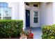 Blue front door entrance with landscaping at 1068 Lake Berkley Dr, Kissimmee, FL 34746