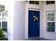 Blue front door with a festive holiday wreath at 1068 Lake Berkley Dr, Kissimmee, FL 34746