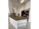 Kitchen boasts granite countertops and black appliances at 1068 Lake Berkley Dr, Kissimmee, FL 34746