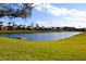 Community lake view with houses at 1068 Lake Berkley Dr, Kissimmee, FL 34746
