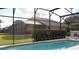 Relaxing pool with a view of the backyard and lake at 1068 Lake Berkley Dr, Kissimmee, FL 34746