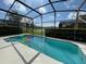 Screened pool with lake view and floating tubes at 1068 Lake Berkley Dr, Kissimmee, FL 34746