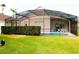 Home with a screened pool and patio at 1068 Lake Berkley Dr, Kissimmee, FL 34746
