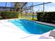Refreshing screened pool area overlooking a serene lake at 1068 Lake Berkley Dr, Kissimmee, FL 34746