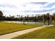 Tennis court with chain link fence and paved walkway at 1068 Lake Berkley Dr, Kissimmee, FL 34746