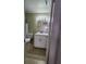 Clean bathroom with white vanity, toilet and a large mirror at 1075 S Hiawassee Rd # 912, Orlando, FL 32835