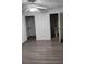 Well-lit bedroom with wood-look floors and walk-in closet at 1075 S Hiawassee Rd # 912, Orlando, FL 32835