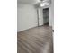 Bedroom with wood-look floors and a large closet at 1075 S Hiawassee Rd # 912, Orlando, FL 32835