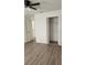 Second bedroom with wood-look floors and a double door closet at 1075 S Hiawassee Rd # 912, Orlando, FL 32835