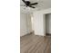 Bright bedroom with wood-look floors and a closet at 1075 S Hiawassee Rd # 912, Orlando, FL 32835
