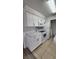 Bright kitchen with white cabinets, granite countertops, and modern appliances at 1075 S Hiawassee Rd # 912, Orlando, FL 32835