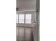 Spacious living room with wood-look floors and large windows at 1075 S Hiawassee Rd # 912, Orlando, FL 32835