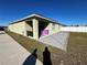 Home exterior showing patio and yard at 120 Panda Way, Davenport, FL 33837