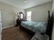 Bright bedroom with teal bedding and wood floors at 120 Panda Way, Davenport, FL 33837