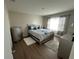 Bedroom with gray and teal bedding and wood floors at 120 Panda Way, Davenport, FL 33837