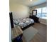 Cozy bedroom with geometric bedding and wood floors at 120 Panda Way, Davenport, FL 33837