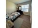 Cozy bedroom with geometric bedding and wood floors at 120 Panda Way, Davenport, FL 33837