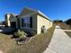 Side view of a one-story house with green siding and landscaping at 120 Panda Way, Davenport, FL 33837