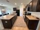 Spacious kitchen with dark wood cabinets and granite countertops at 120 Panda Way, Davenport, FL 33837