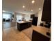 Kitchen with island, dark cabinets, and granite countertops at 120 Panda Way, Davenport, FL 33837