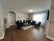 Living room with hardwood floors and comfortable navy blue furniture at 120 Panda Way, Davenport, FL 33837