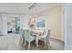 Elegant dining room with a wood table, light-colored chairs, and patterned wallpaper at 12549 Encore At Ovation Way, Winter Garden, FL 34787