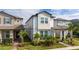 Two-story home with light-colored siding, landscaping, and a paved walkway at 12549 Encore At Ovation Way, Winter Garden, FL 34787