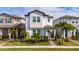 Two-story home with light-colored siding, landscaping, and a paved walkway at 12549 Encore At Ovation Way, Winter Garden, FL 34787