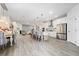 Open concept kitchen with island, stainless steel appliances, and light wood floors at 12549 Encore At Ovation Way, Winter Garden, FL 34787