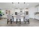 Kitchen island with seating for three, white quartz countertops and gray cabinets at 12549 Encore At Ovation Way, Winter Garden, FL 34787