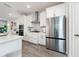 Modern kitchen with stainless steel appliances and white shaker cabinets at 12549 Encore At Ovation Way, Winter Garden, FL 34787