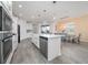 Modern kitchen with stainless steel appliances, white cabinetry, and a large island at 12549 Encore At Ovation Way, Winter Garden, FL 34787