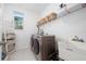Bright laundry room with washer, dryer, and extra storage at 12549 Encore At Ovation Way, Winter Garden, FL 34787
