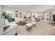 Open living room showcasing a white sectional sofa, stylish coffee table, and wood-look floors at 12549 Encore At Ovation Way, Winter Garden, FL 34787