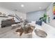 Spacious living area featuring a white sectional sofa, accent pieces, and wood-look floors at 12549 Encore At Ovation Way, Winter Garden, FL 34787