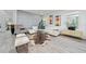 Bright living room with white sectional sofa, accent chairs, and a large statement wall at 12549 Encore At Ovation Way, Winter Garden, FL 34787