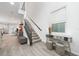 Modern staircase with dark metal railing and light wood steps at 12549 Encore At Ovation Way, Winter Garden, FL 34787